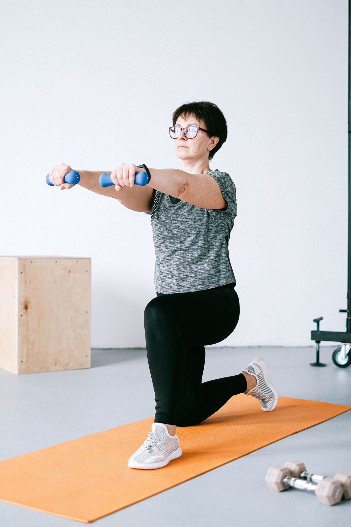 Older woman lifting small weights